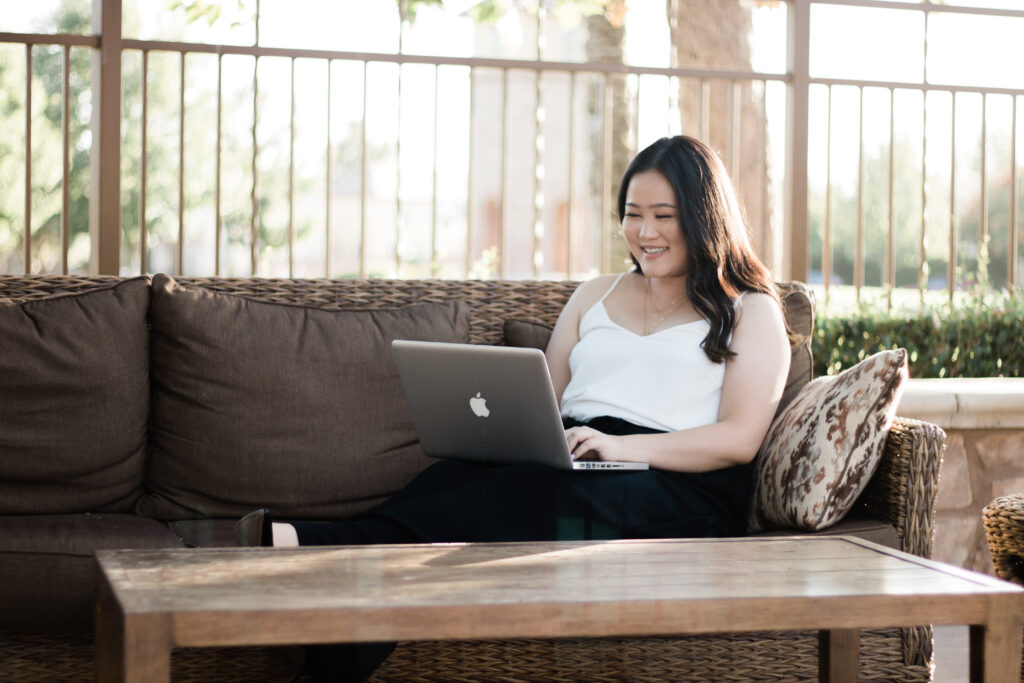 Photo of Karey Cha working on a laptop.